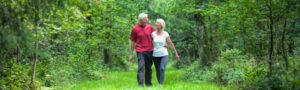 Senior couple walking together in the woods
