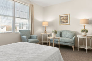 seating area in the bedroom of an assisted living memory care apartment at Allerton House in Weymouth