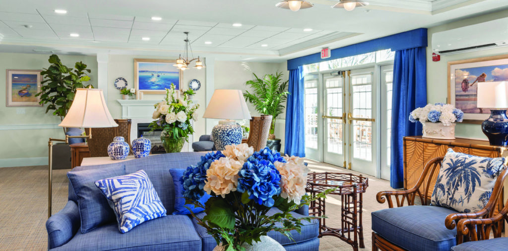 Comfortable common living area filled with blue and white floral arrangements